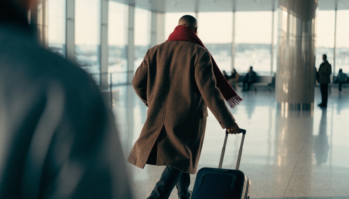 A traveller in an airport arrivals hall