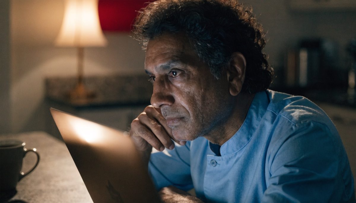 Person reading immigration updates on a laptop at a desk